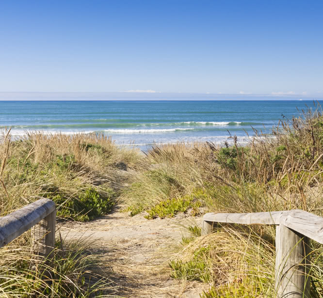 Wood railings leading to beach dunes